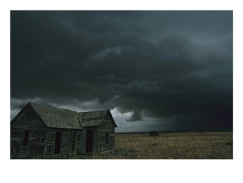 heavy-dark-clouds-foretell-a-possible-tornado-near-an-old-homestead-photographic-print-c12665950.jpeg
